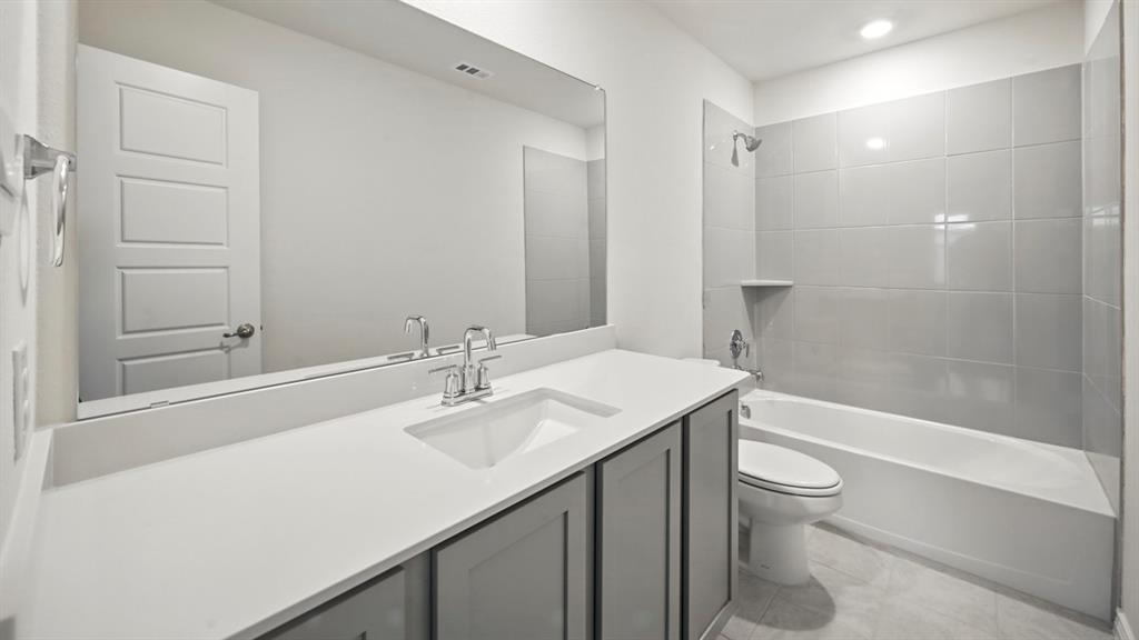 Full bathroom featuring vanity, shower / washtub combination, and light tile patterned flooring