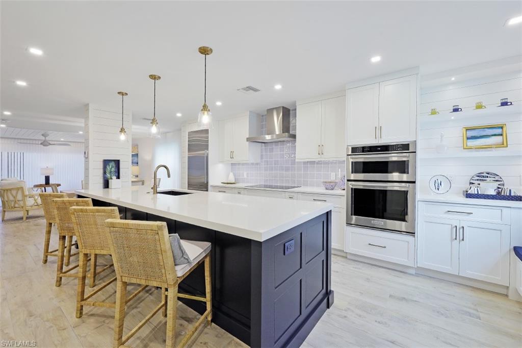a kitchen with stainless steel appliances kitchen island granite countertop a sink and cabinets