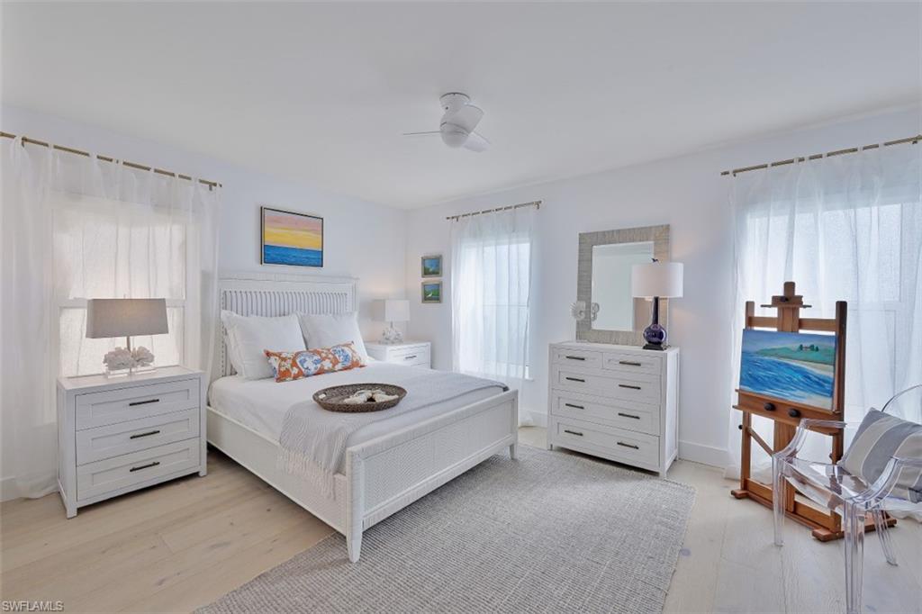 1060 6th Street South, Unit 1060 Naples, FL 34102 - Photo 16 of 31 a bedroom with a bed and a dresser in it