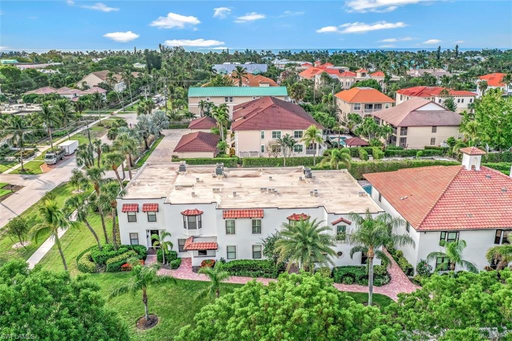 1060 6th Street South, Unit 1060 Naples, FL 34102 - Photo 20 of 31 an aerial view of multiple houses with a yard