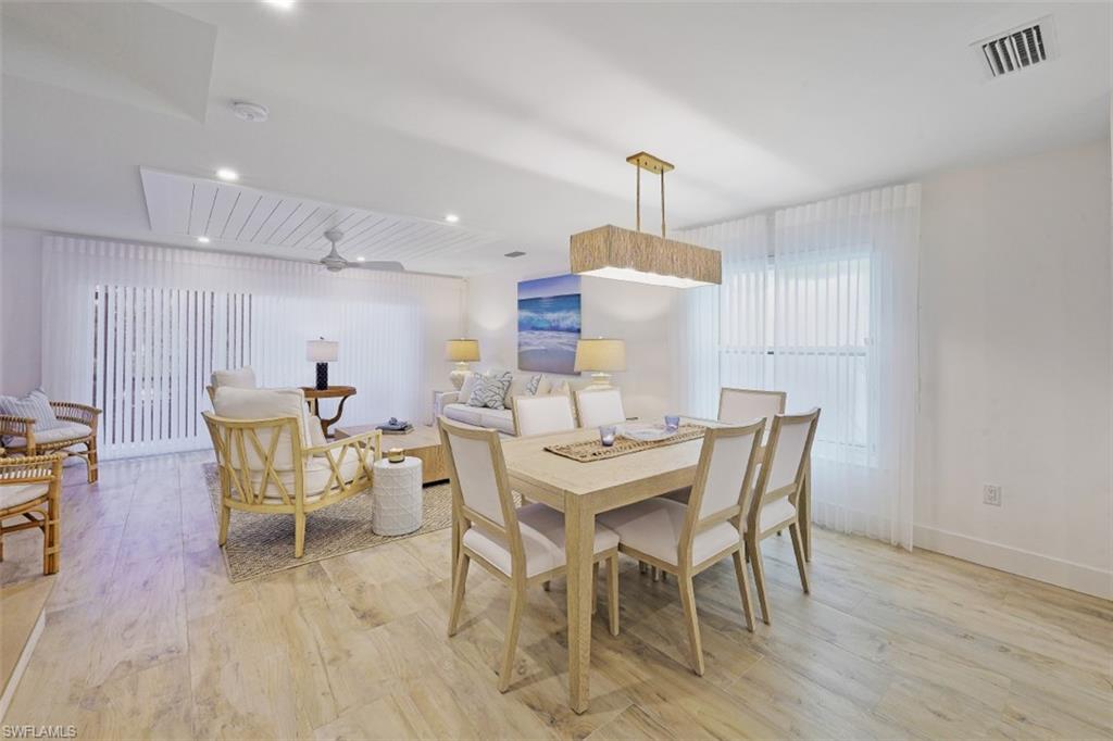 1060 6th Street South, Unit 1060 Naples, FL 34102 - Photo 6 of 31 a view of a dining room with furniture