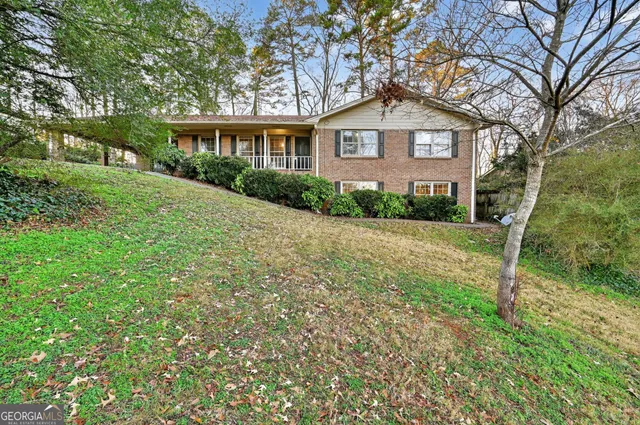 a front view of a house with yard and green space