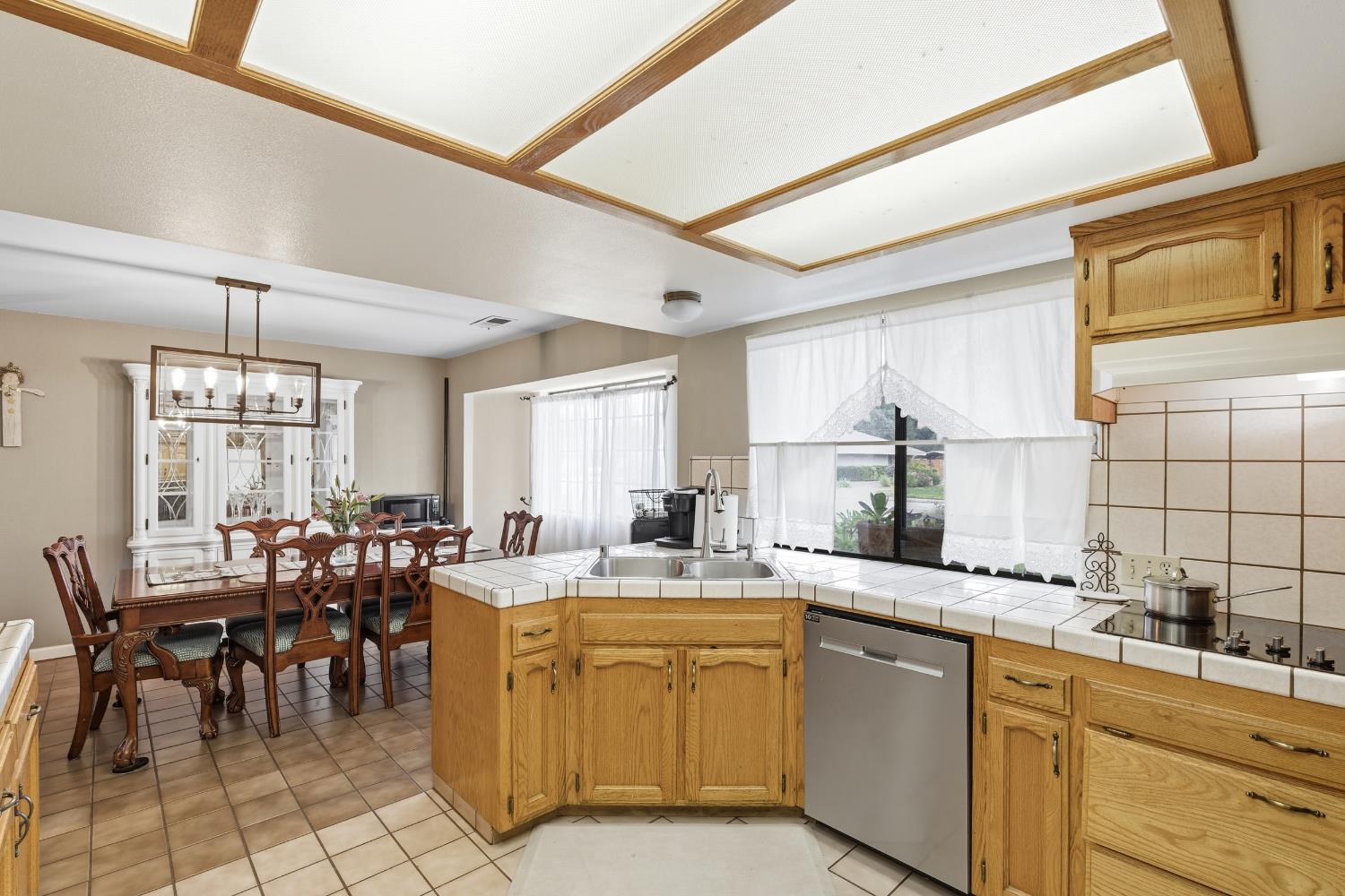 12126 Topper Road Madera, CA 93636 - Photo 13 of 40 a room with stainless steel appliances kitchen island granite countertop furniture a sink and a window