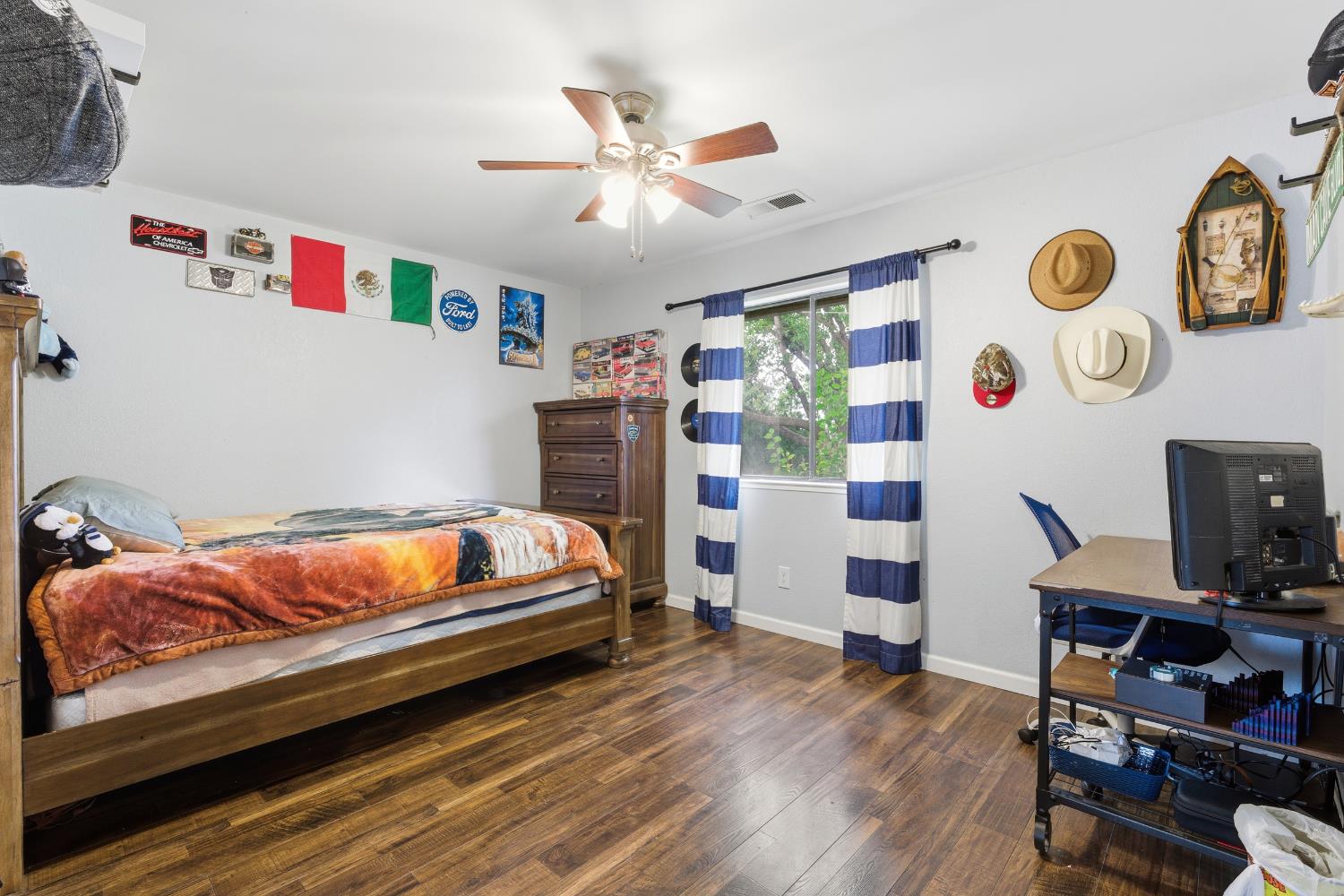 12126 Topper Road Madera, CA 93636 - Photo 19 of 40 a bedroom with a bed and a bookshelf