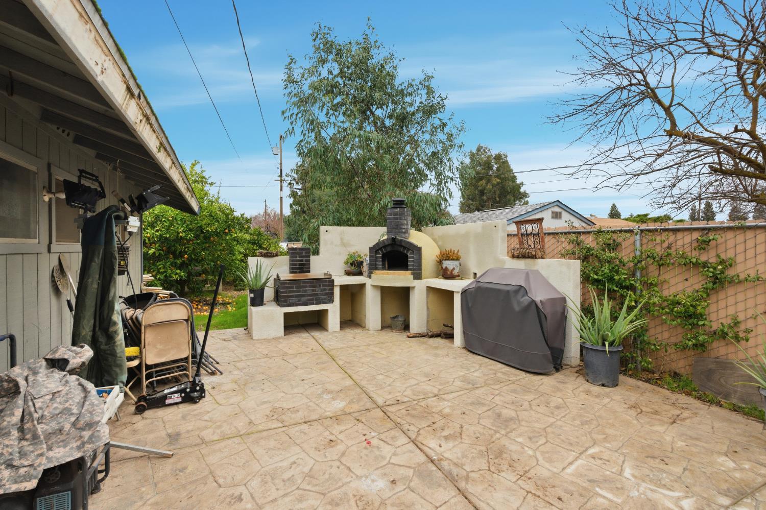 12126 Topper Road Madera, CA 93636 - Photo 26 of 40 a view of a patio with table and chairs and potted plants