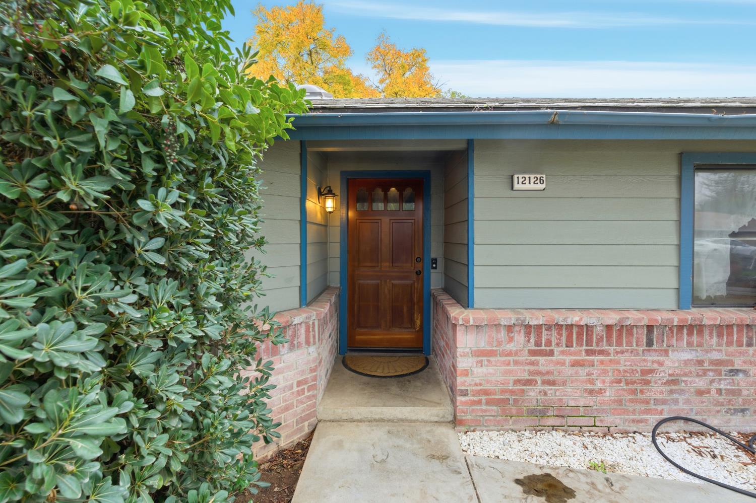 12126 Topper Road Madera, CA 93636 - Photo 3 of 40 a front view of a house with garden