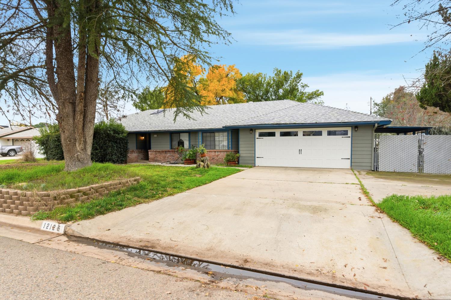 12126 Topper Road Madera, CA 93636 - Photo 33 of 40 a front view of a house with a garden