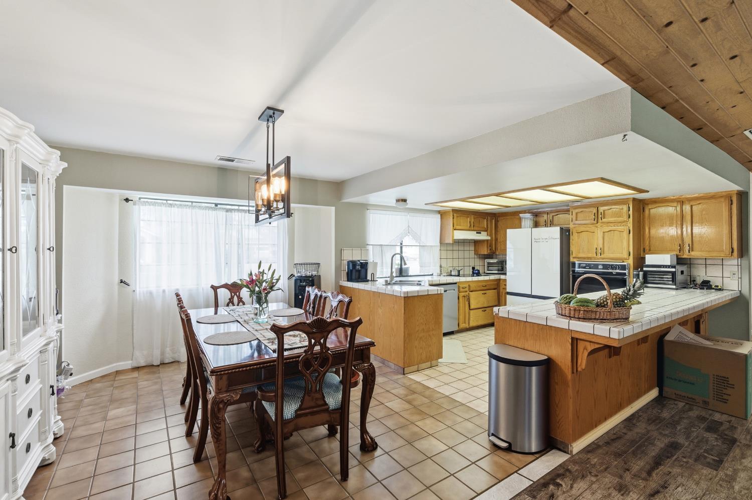 12126 Topper Road Madera, CA 93636 - Photo 9 of 40 a view of a dining room with furniture window and wooden floor