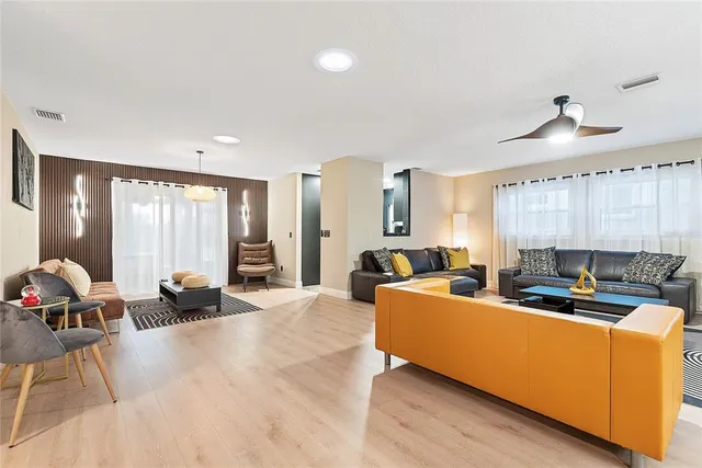 a kitchen with stainless steel appliances granite countertop a stove refrigerator and a fireplace