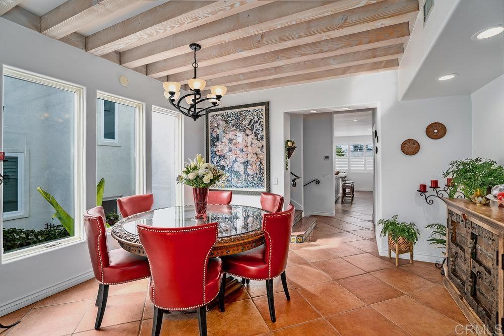 332 Gravilla Street La Jolla, CA 92037 - Photo 12 of 49 a dining room with furniture potted plants and wooden floor