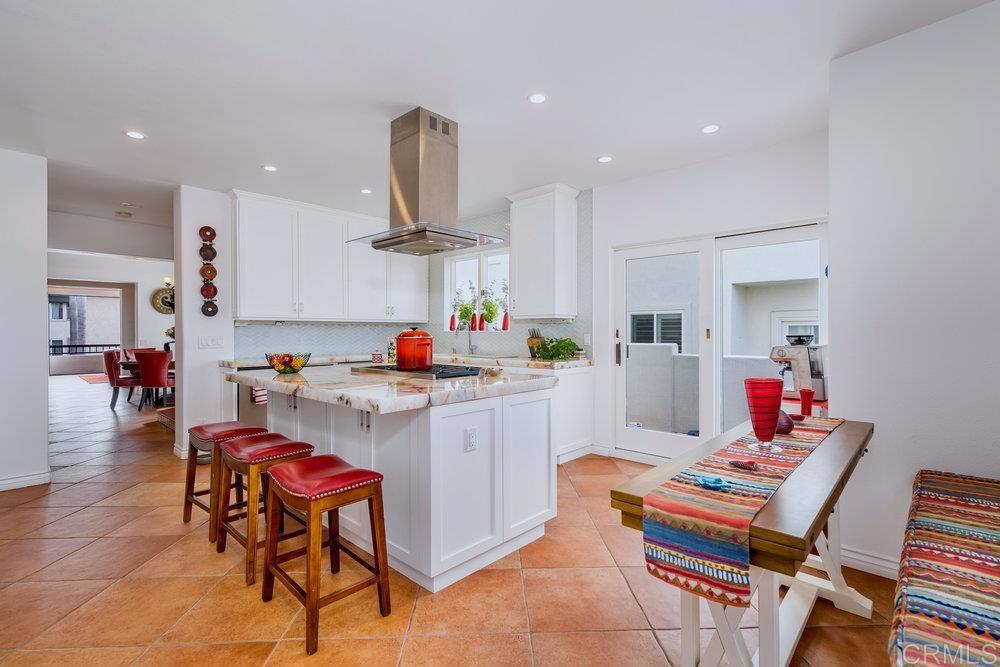 332 Gravilla Street La Jolla, CA 92037 - Photo 14 of 49 a room with stainless steel appliances kitchen island granite countertop a dining table chairs and sink
