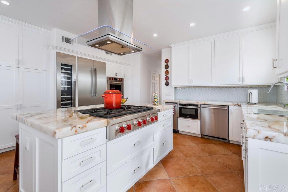 332 Gravilla Street La Jolla, CA 92037 - Photo 16 of 49 a kitchen with a stove top oven sink and cabinets