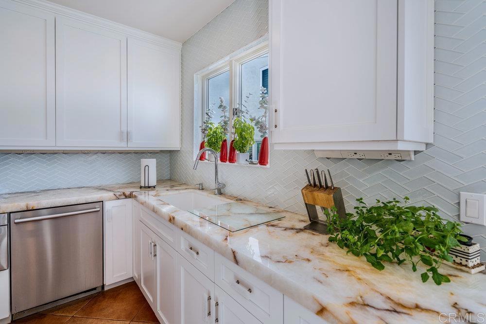 332 Gravilla Street La Jolla, CA 92037 - Photo 17 of 49 a kitchen with a sink and cabinets