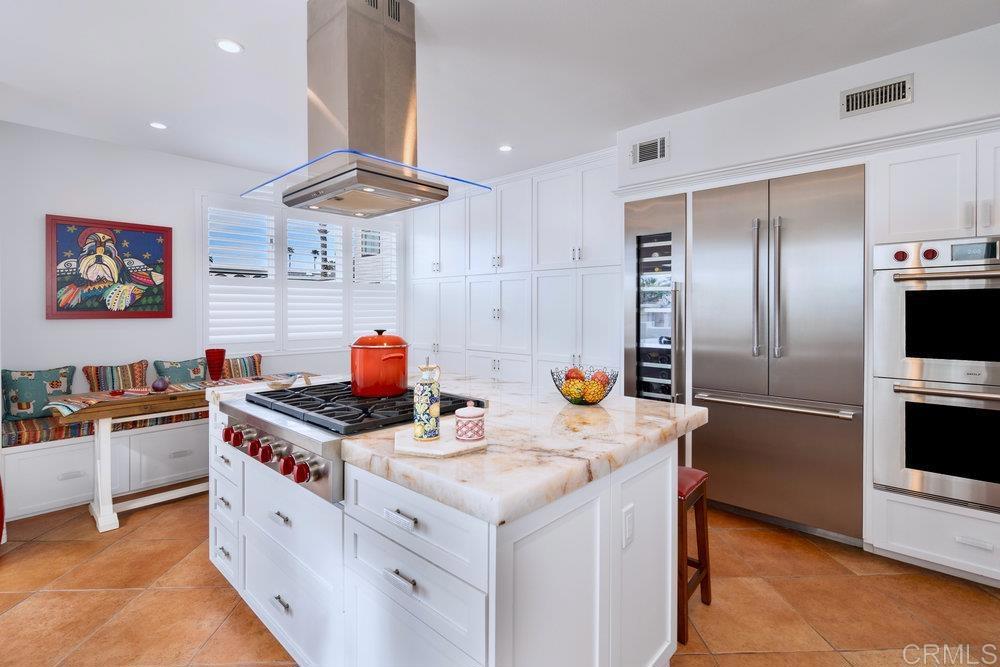 332 Gravilla Street La Jolla, CA 92037 - Photo 18 of 49 a kitchen with stainless steel appliances granite countertop a sink and a refrigerator