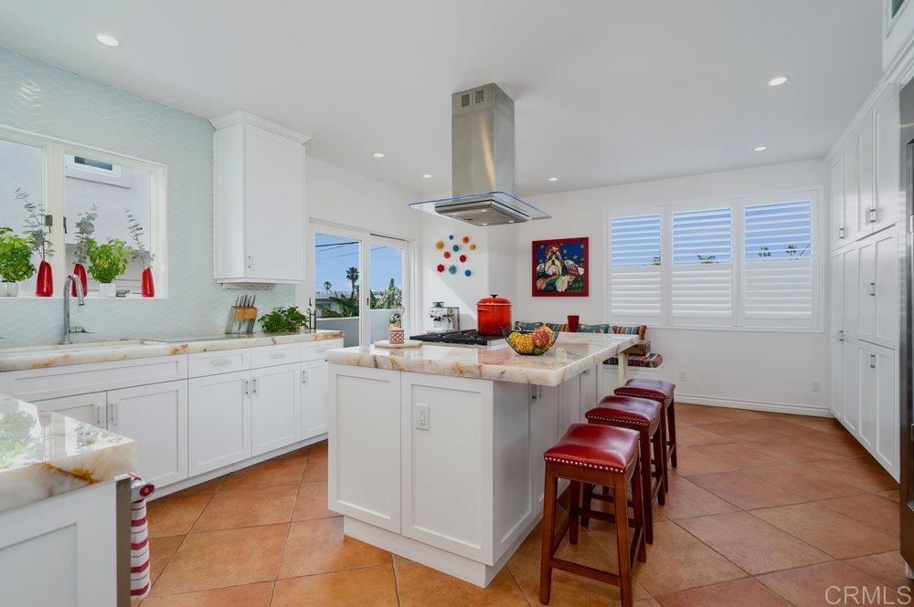 332 Gravilla Street La Jolla, CA 92037 - Photo 19 of 49 a kitchen with furniture a center island stainless steel appliances cabinets and a window