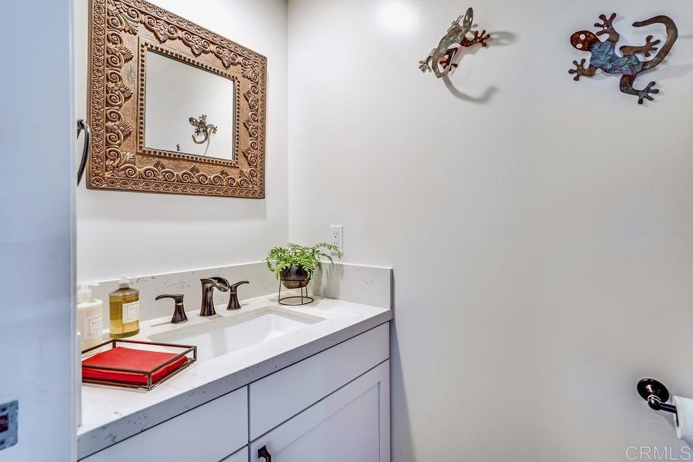 332 Gravilla Street La Jolla, CA 92037 - Photo 21 of 49 a bathroom with a granite countertop sink and a mirror