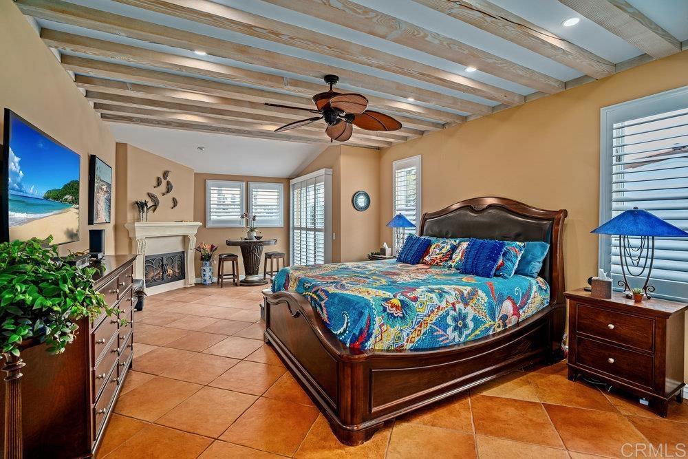 332 Gravilla Street La Jolla, CA 92037 - Photo 24 of 49 a bedroom with a bed and a chandelier