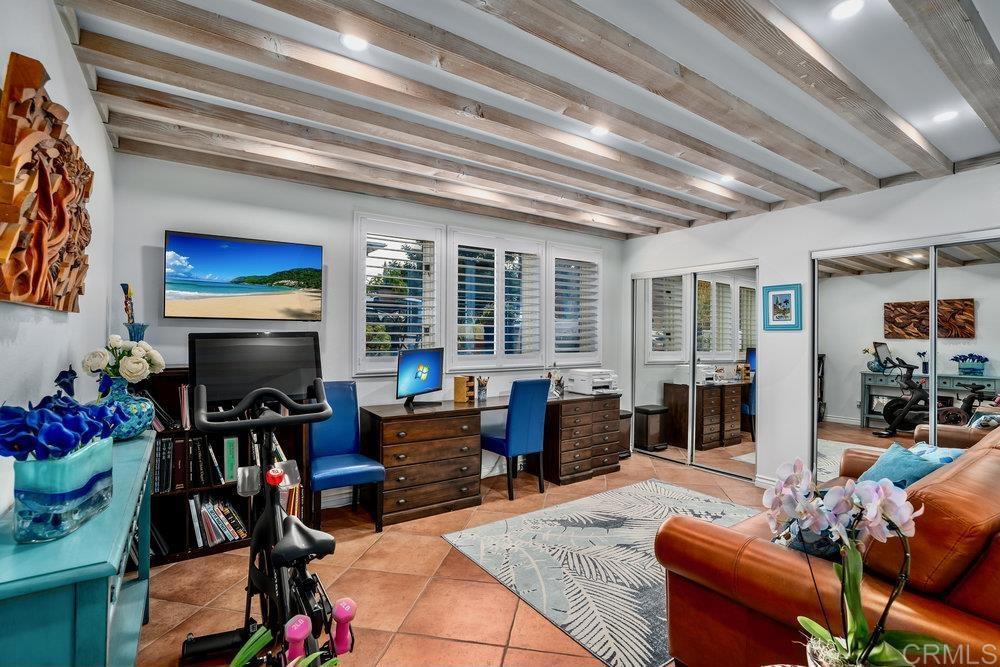 332 Gravilla Street La Jolla, CA 92037 - Photo 39 of 49 a living room with furniture a flat screen tv and a floor to ceiling window
