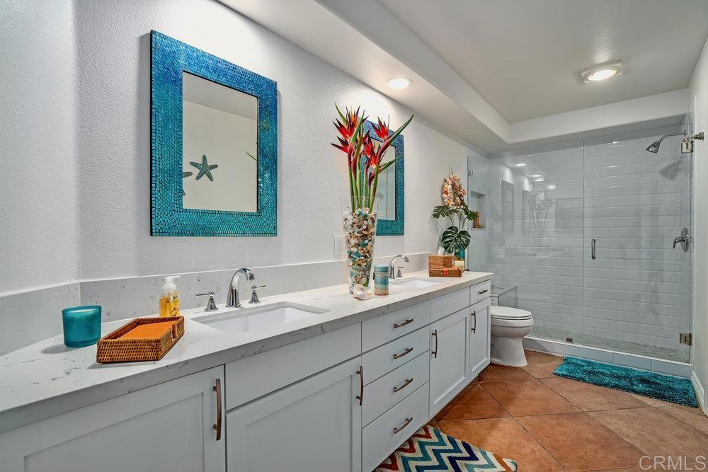 332 Gravilla Street La Jolla, CA 92037 - Photo 41 of 49 a bathroom with a double vanity sink mirror double and shower