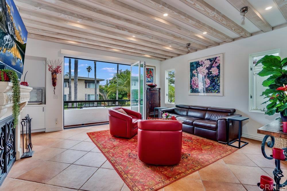 332 Gravilla Street La Jolla, CA 92037 - Photo 7 of 49 a living room with furniture a floor to ceiling window and potted plant