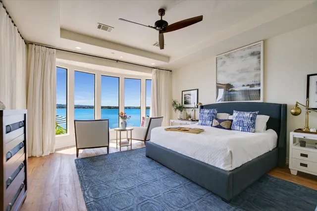 a bedroom with a large bed couch and a window