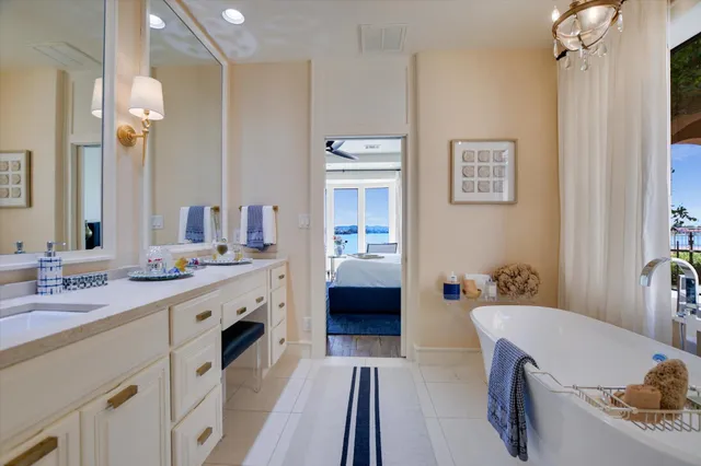 a spacious bathroom with a tub sink and mirror