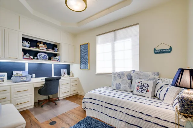 a bedroom with a bed a desk and chair