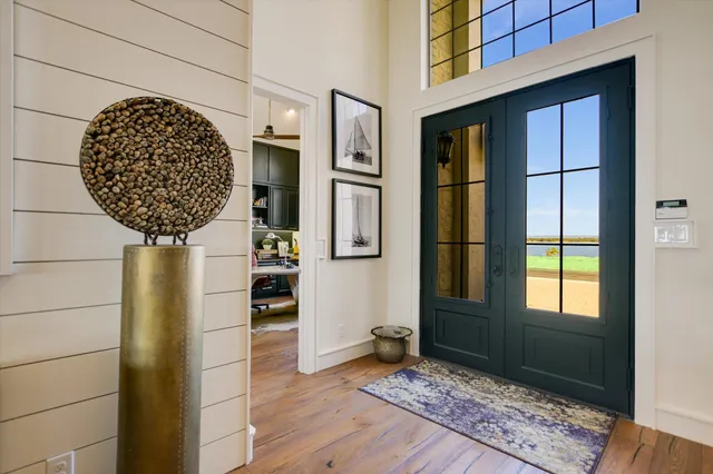 a picture of a door and chair in a room