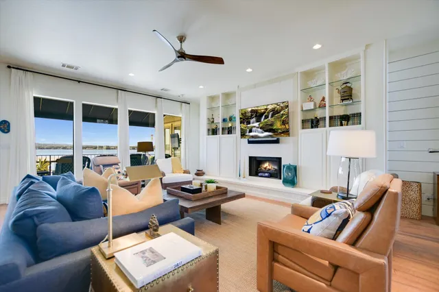 a living room with furniture fireplace and flat screen tv