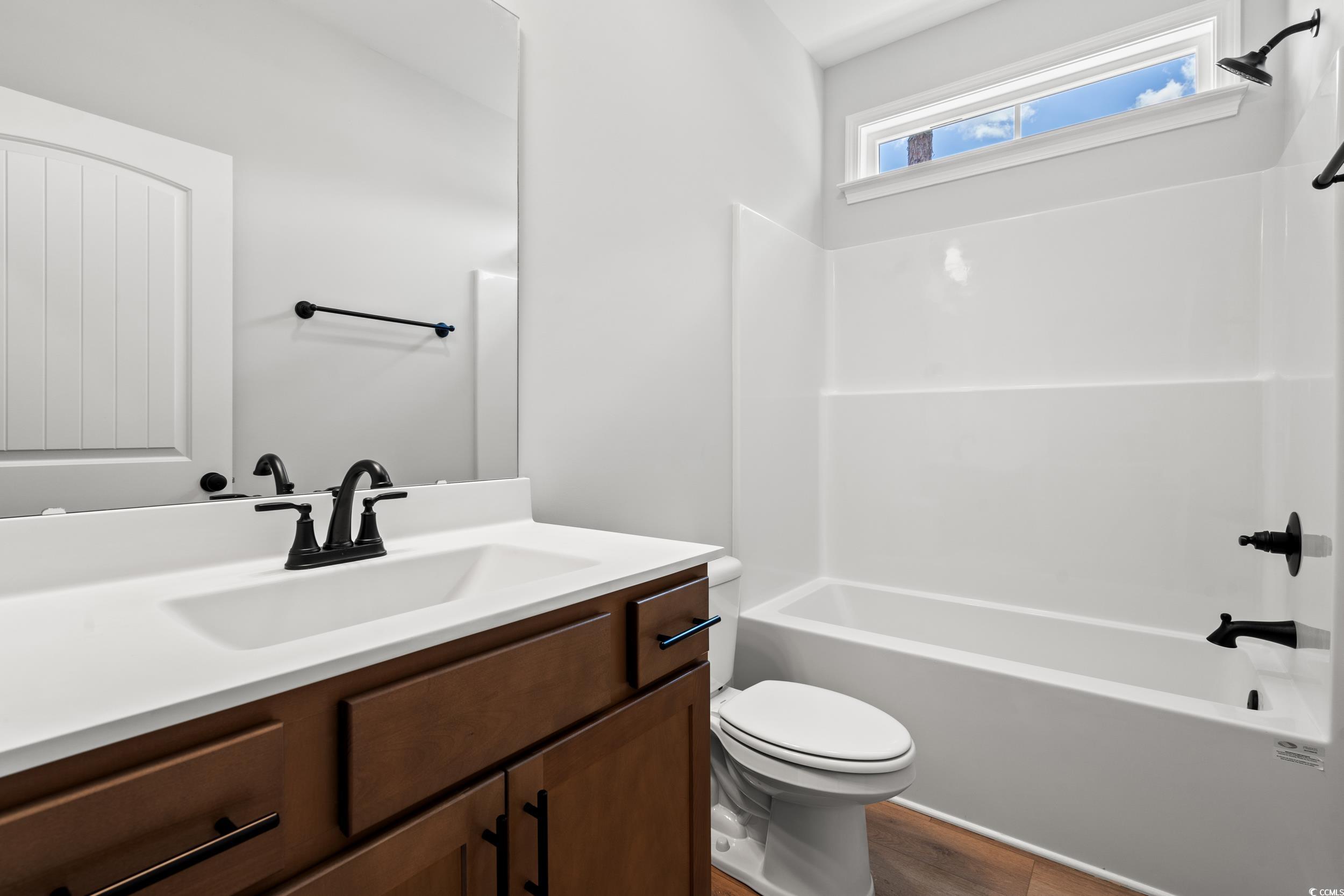 839 Francis Parker Road Georgetown, SC 29440 - Photo 6 of 38 Bathroom with vanity, washtub / shower combination, and wood finished floors
