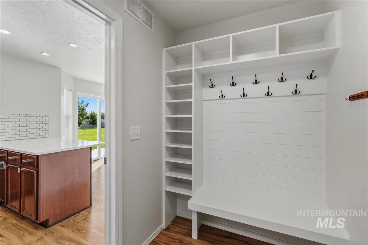 12310 West Hidden Point Drive Star, ID 83669 - Photo 13 of 48 Built-in mudroom bench with shiplap backing, integrated shelving, and multiple coat hooks