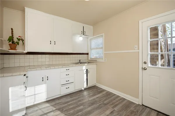 a view of a kitchen with wooden floor
