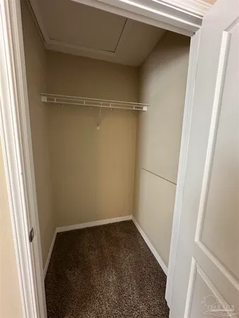 a bathroom with a granite countertop sink mirror vanity and toilet