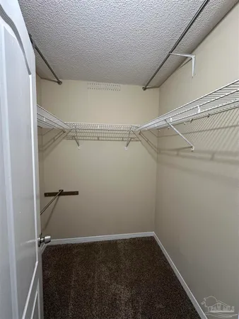 a view of an empty room with a ceiling fan