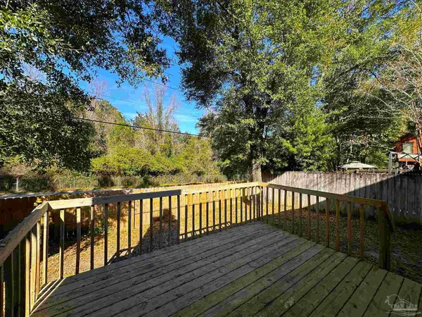a view of a yard with wooden fence and a porch