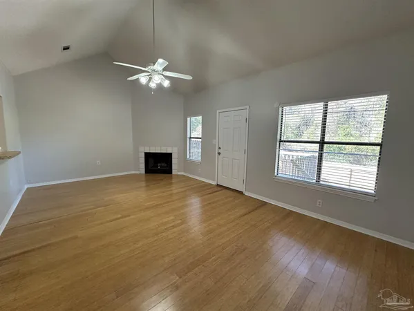 wooden floor in an empty room with a window