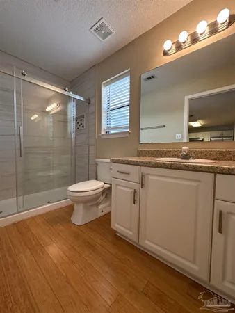 a bathroom with a sink toilet and shower