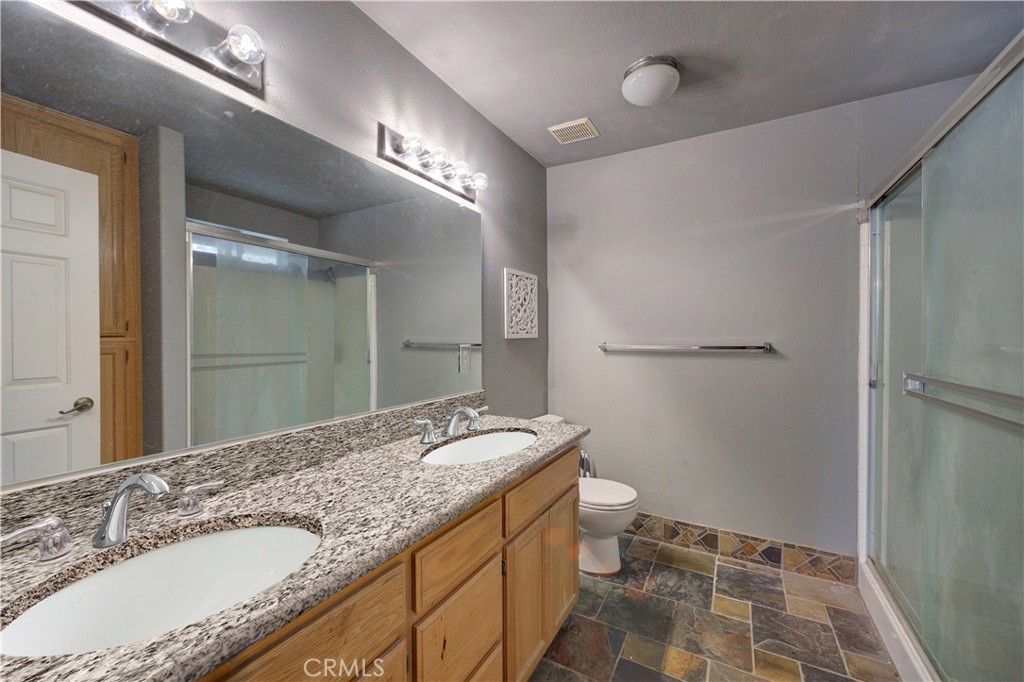 4850 Jardine Road Paso Robles, CA 93446 - Photo 12 of 19 a bathroom with a granite countertop sink a mirror and a toilet