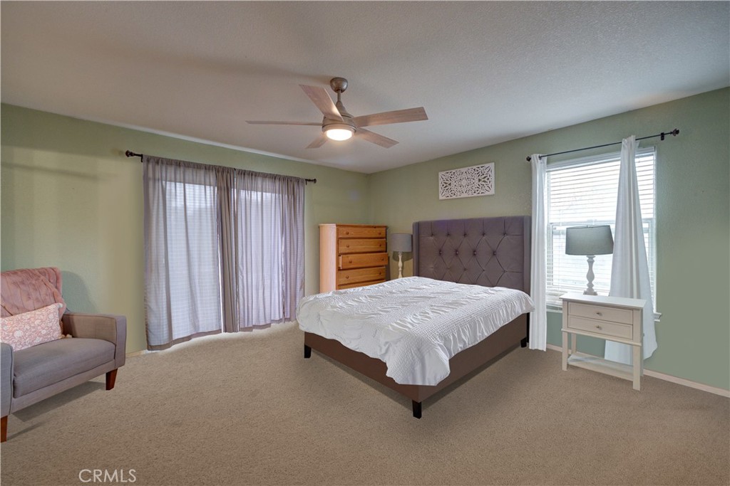 4850 Jardine Road Paso Robles, CA 93446 - Photo 10 of 19 a spacious bedroom with a bed painting on wall and windows