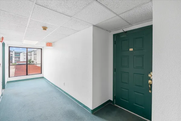 a view of hallway with window and stairs