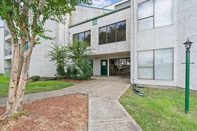 a front view of a house with a garden and yard
