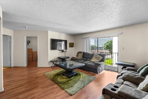 a living room with furniture window and a flat screen tv