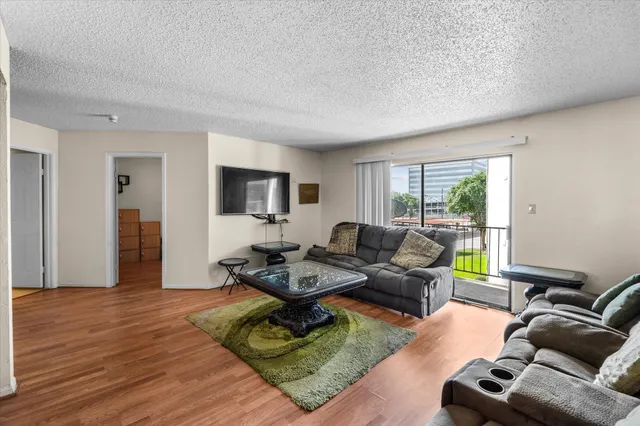 a living room with furniture window and a flat screen tv