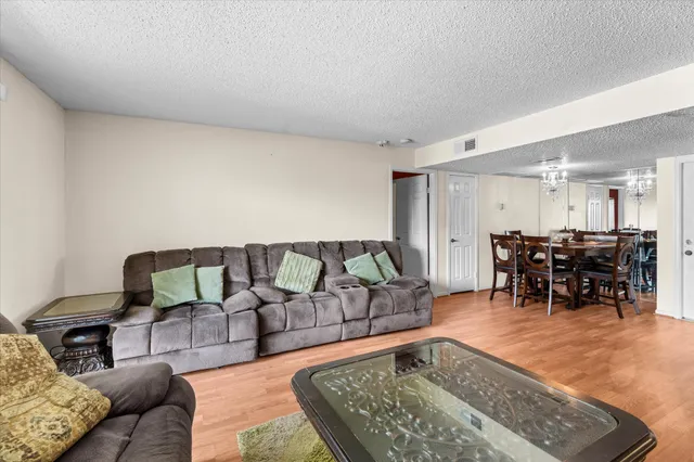 a living room with furniture and dining area