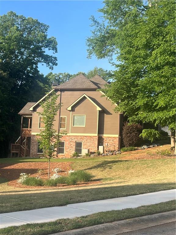 348 Hidden Trail Pendergrass, GA 30567 - Photo 5 of 40 a view of a house with a yard and large tree