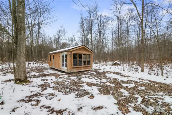 a view of a house with a yard covered in snow