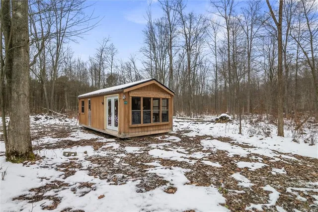 a view of a house with a yard covered in snow