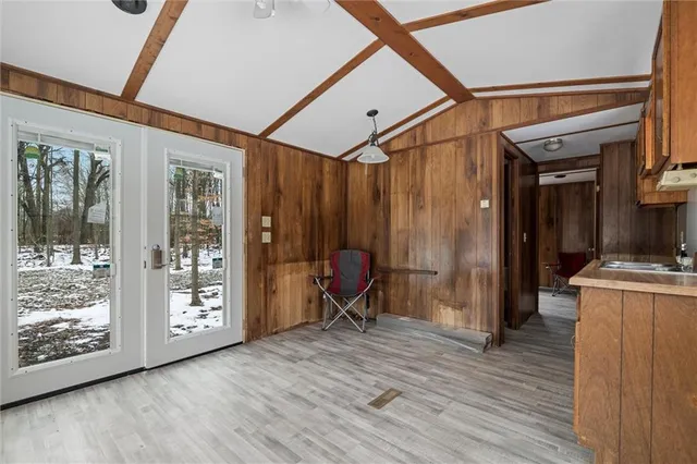 a view of a kitchen with furniture and wooden floor