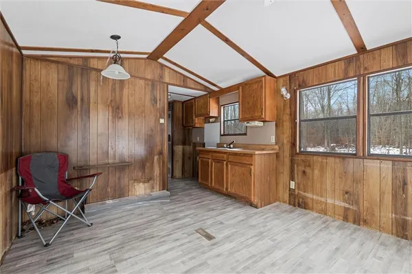 a kitchen with stainless steel appliances wooden floors and wooden cabinets