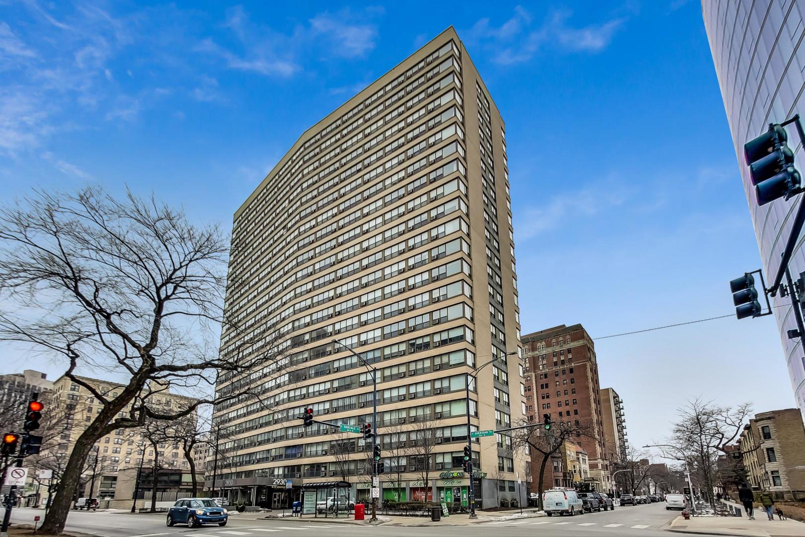 2930 North Sheridan Road, Unit 802 Chicago, IL 60657 - Photo 1 of 30 a front view of a building with large trees